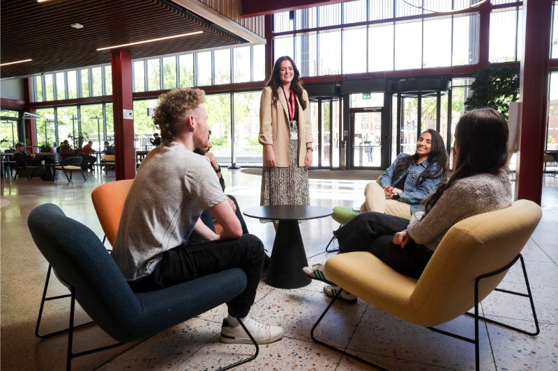 staff member standing next to a table of students